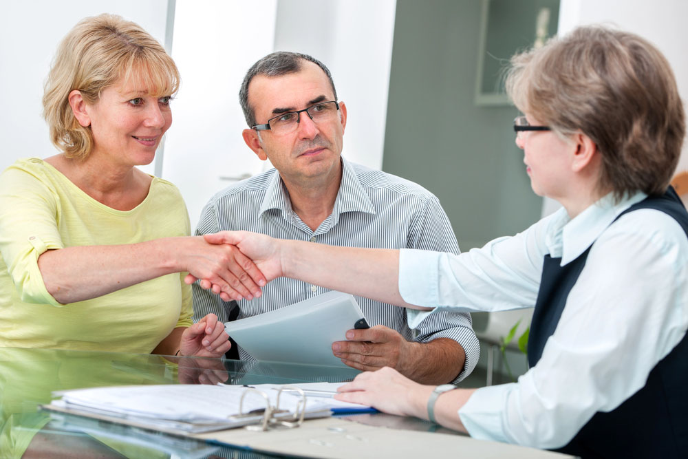 Mature couple getting financial advice from consultant at home